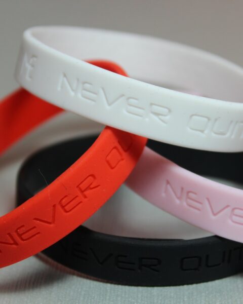 Never Quit Me Motivational Silicone Bracelet, debossed pink